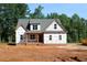 New two-story home exterior with gray roof, large windows and a brick foundation at 25 Autumnwood Ln, Spring Hope, NC 27882