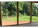 Cozy porch showcasing beautiful views of the lush, green backyard at 25 Autumnwood Ln, Spring Hope, NC 27882