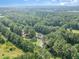 Overhead aerial of the property showing the house nestled among lush trees and manicured lawn at 255 Morris Rd, Pittsboro, NC 27312