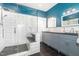 A modern bathroom features a sleek glass shower, dual sinks, and stylish dark flooring at 255 Morris Rd, Pittsboro, NC 27312