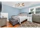 Inviting bedroom featuring a wrought iron bed frame, light blue walls, and a cozy rug at 255 Morris Rd, Pittsboro, NC 27312