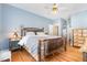 Charming bedroom featuring a unique wood-frame bed, light blue walls, and hardwood floors at 255 Morris Rd, Pittsboro, NC 27312