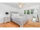 Cozy bedroom with light gray walls, hardwood floors, and natural light from large window at 255 Morris Rd, Pittsboro, NC 27312