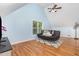 Bright bonus room with wood floors, vaulted ceiling, large window, and comfortable seating at 255 Morris Rd, Pittsboro, NC 27312