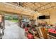 View of the spacious garage with ceiling fans, an open door and tools on shelves at 255 Morris Rd, Pittsboro, NC 27312