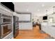 A well-appointed kitchen features white cabinets, stainless appliances, and an open floor plan at 255 Morris Rd, Pittsboro, NC 27312