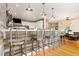 An open kitchen with a bar island featuring a quartz countertop, and stylish seating at 255 Morris Rd, Pittsboro, NC 27312