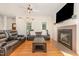 Bright living room with hardwood floors, fireplace, and natural light at 255 Morris Rd, Pittsboro, NC 27312