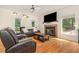 Cozy living room with fireplace, hardwood floors, and ample natural light at 255 Morris Rd, Pittsboro, NC 27312