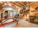 Spacious recreation room featuring wooden walls, vaulted ceilings, mounted deer, and a large custom picnic table at 255 Morris Rd, Pittsboro, NC 27312