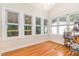 Sunroom with hardwood flooring and many large windows offering beautiful natural light at 255 Morris Rd, Pittsboro, NC 27312