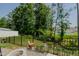 Relaxing backyard featuring a stone fire pit, seating, and privacy fence at 2586 Lacey Holt Rd, Graham, NC 27253