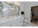 Bright bathroom with a double sink vanity, decorated mirror, and walk-in closet at 2586 Lacey Holt Rd, Graham, NC 27253