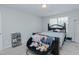 This bedroom features light walls, carpet, a ceiling fan, and a small window at 2586 Lacey Holt Rd, Graham, NC 27253