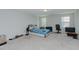 Spacious bedroom features carpet flooring, natural light, and ceiling fan at 2586 Lacey Holt Rd, Graham, NC 27253