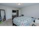 This bedroom features light walls, carpet, a ceiling fan, and a nearby bathroom at 2586 Lacey Holt Rd, Graham, NC 27253