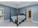 This bedroom features a four-post bed, tray ceiling, and a walk-in closet at 2586 Lacey Holt Rd, Graham, NC 27253