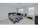 This bedroom features light walls, carpet, a ceiling fan, and two windows at 2586 Lacey Holt Rd, Graham, NC 27253