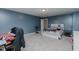 This bedroom features blue walls, carpet, a ceiling fan, and a nearby bathroom at 2586 Lacey Holt Rd, Graham, NC 27253