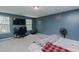 This bedroom features blue walls, carpet, a ceiling fan, and a pair of windows at 2586 Lacey Holt Rd, Graham, NC 27253