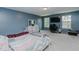 This bedroom features blue walls, carpet, a ceiling fan, and a pair of windows at 2586 Lacey Holt Rd, Graham, NC 27253