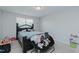 This bedroom features light walls, carpet, a ceiling fan, and a small window at 2586 Lacey Holt Rd, Graham, NC 27253