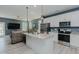 Kitchen with island seating flows into the living room; stainless appliances; and granite counters at 2586 Lacey Holt Rd, Graham, NC 27253