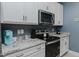 Stylish kitchen with stainless appliances, white cabinets, and granite countertops at 2586 Lacey Holt Rd, Graham, NC 27253