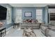 Comfortable living room with a gray sofa set, light wood floors, and light blue walls at 2586 Lacey Holt Rd, Graham, NC 27253