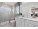 Modern bathroom featuring double vanity sinks, tiled shower with glass door, and contemporary fixtures at 2799 Cassius Dr, Apex, NC 27502
