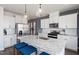Modern kitchen features stainless steel appliances, white cabinetry, granite counters, and a spacious center island at 2799 Cassius Dr, Apex, NC 27502