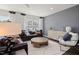 Spacious living room with hardwood floors, large windows, modern decor, and a comfortable seating arrangement at 2799 Cassius Dr, Apex, NC 27502