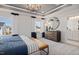 Serene main bedroom featuring soft carpet, large windows, a chandelier, and ample space at 2799 Cassius Dr, Apex, NC 27502