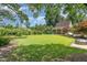 Expansive backyard features a manicured lawn, detached structure, and brick firepit at 2945 Chimney Hill Trl, Rocky Mount, NC 27804