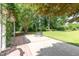 Backyard featuring a stone fire pit, lush lawn, and mature trees at 2945 Chimney Hill Trl, Rocky Mount, NC 27804