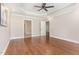 Spacious primary bedroom with ensuite bathroom, ceiling fan and hardwood floors at 2945 Chimney Hill Trl, Rocky Mount, NC 27804