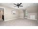 Neutral bonus room featuring plush carpeting, ceiling fan, and built-in nook with natural lighting at 2945 Chimney Hill Trl, Rocky Mount, NC 27804