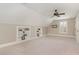 Finished bonus room with carpet, ceiling fan and built-in shelves perfect for extra storage at 2945 Chimney Hill Trl, Rocky Mount, NC 27804