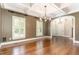 Spacious dining room featuring hardwood floors, coffered ceiling, and ample natural light at 2945 Chimney Hill Trl, Rocky Mount, NC 27804