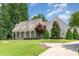 Charming home exterior featuring a welcoming front porch, manicured lawn, and established landscaping at 2945 Chimney Hill Trl, Rocky Mount, NC 27804