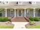 Welcoming front entrance with brick steps, black railings, and classic columns at 2945 Chimney Hill Trl, Rocky Mount, NC 27804