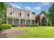 Inviting front porch with classic columns, brick steps, and meticulously maintained landscaping at 2945 Chimney Hill Trl, Rocky Mount, NC 27804