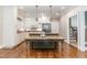 A gourmet kitchen featuring a large island with stone countertops and seating, accented by pendant lighting at 2945 Chimney Hill Trl, Rocky Mount, NC 27804