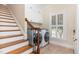 Bright laundry room with modern appliances, ample cabinet storage, and a window with natural light at 2945 Chimney Hill Trl, Rocky Mount, NC 27804