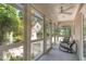 Relaxing screened-in porch with seating, ceiling fan, and views of the lush backyard at 2945 Chimney Hill Trl, Rocky Mount, NC 27804