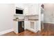 Stylish wet bar with granite countertop, beverage fridge, custom cabinets and a built-in entertainment area at 2945 Chimney Hill Trl, Rocky Mount, NC 27804