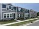 Charming townhouse exterior showcasing a mix of siding and brick, complemented by landscaped greenery at 3010 Fulong Dr, Durham, NC 27704