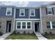 Charming townhouse exterior showcasing a mix of siding and brick, complemented by landscaped greenery at 3010 Fulong Dr, Durham, NC 27704