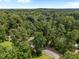 Scenic aerial view of a property nestled amongst a canopy of trees, providing a sense of seclusion at 308 Fleming Dr, Durham, NC 27712