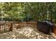 Outdoor deck with wood railings and stairs. A grill is on the deck at 308 Fleming Dr, Durham, NC 27712